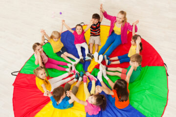 Kids,Holding,Hands,Together,With,Teacher,In,Gym